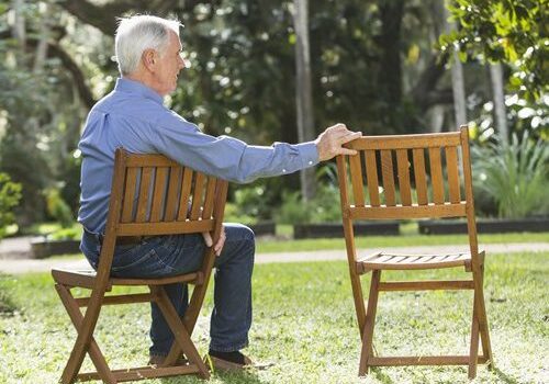 elderly gentleman holding a chair